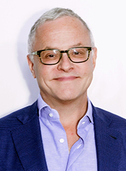 Neal Baer smiling into the camera in a formal headshot.