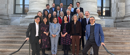 Group of alumni standing on the steps of Gordon Hall.