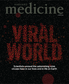 Cover of Spring 2022 issue of Harvard Medical magazine with red virus microbes spelling out the words viral world.  