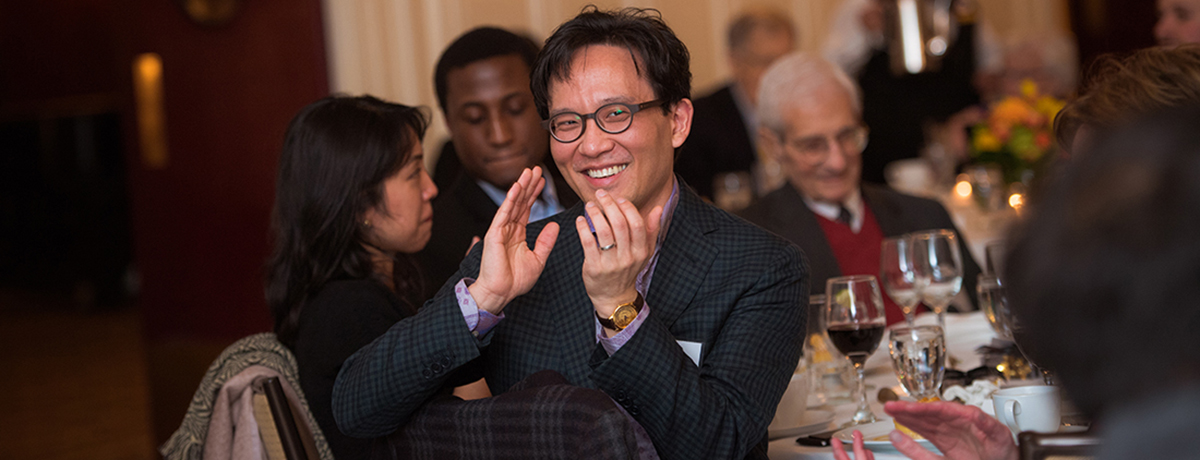 Photo of gentleman clapping during an appreciation dinner.